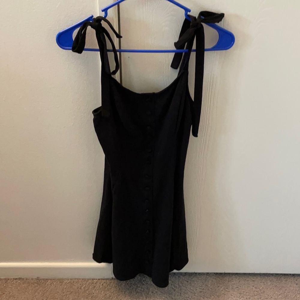 Black dress with bows and buttons down the front.